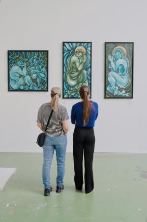  Visitors view three paintings " 'The Bath', 'Meandering River' and 'Sleeping River'